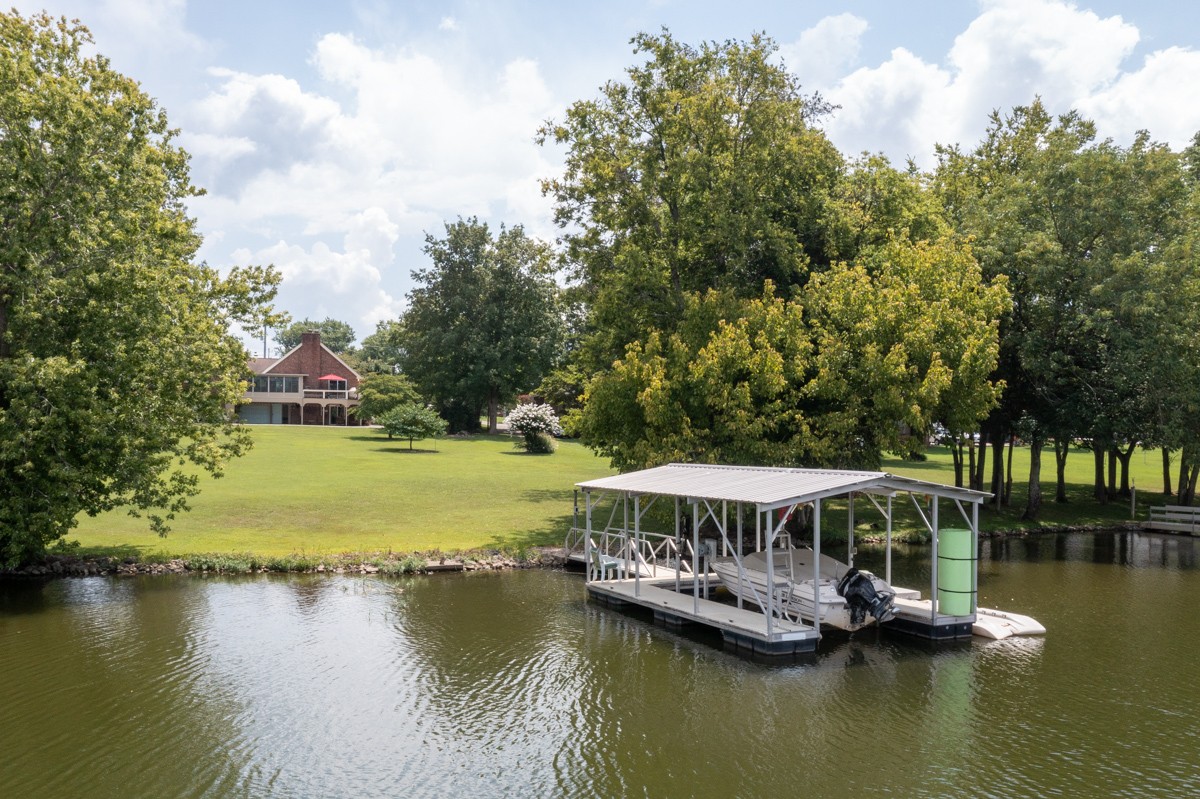 1069 Edgewater Circle Gallatin, TN 37066 - Photo 38 of 43 a view of a lake with a house in the background