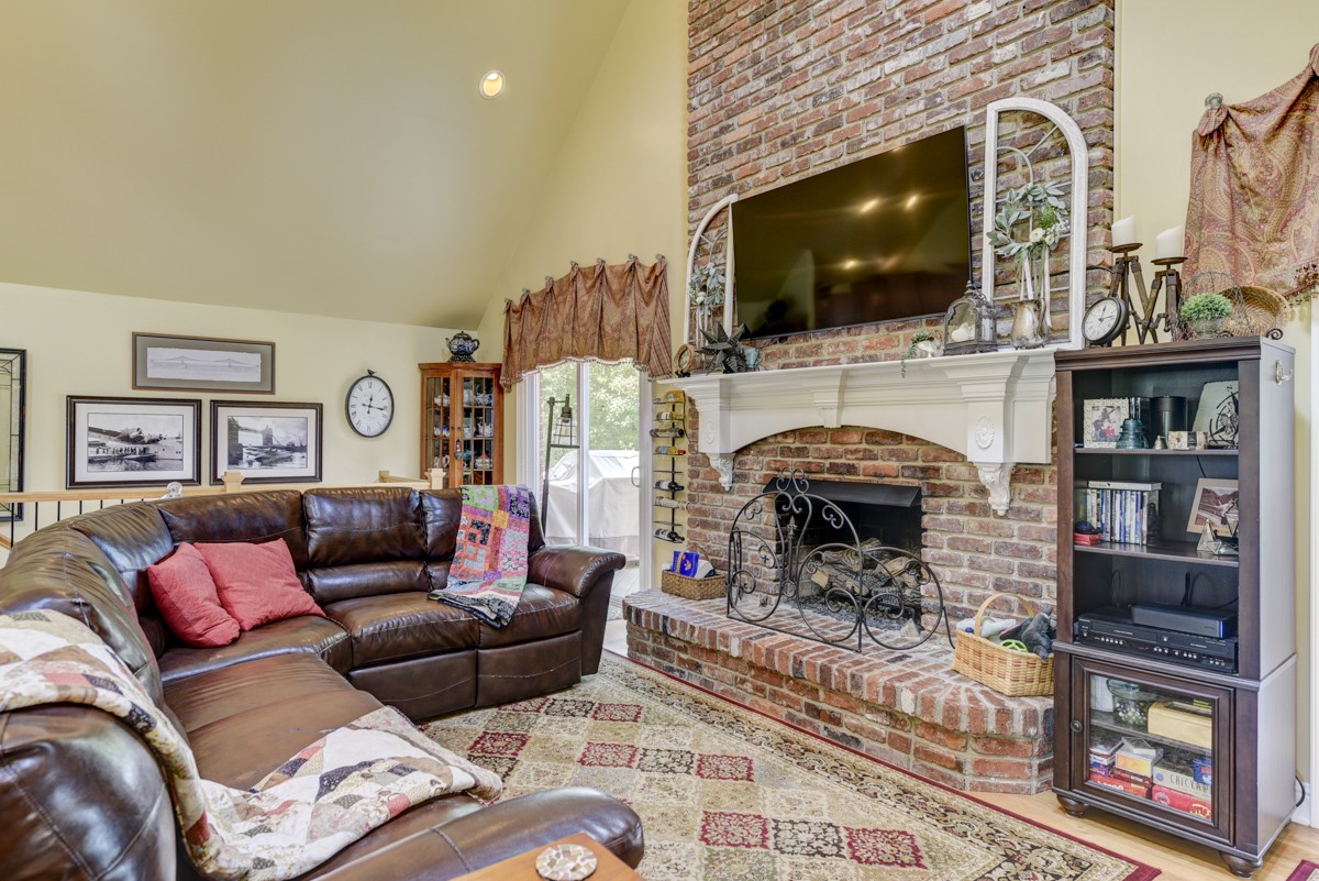 1069 Edgewater Circle Gallatin, TN 37066 - Photo 6 of 43 a living room with furniture a flat screen tv and a fireplace