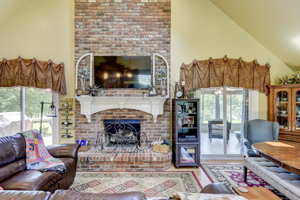 1069 Edgewater Circle Gallatin, TN 37066 - Photo 9 of 43 a living room with furniture a flat screen tv and a fireplace