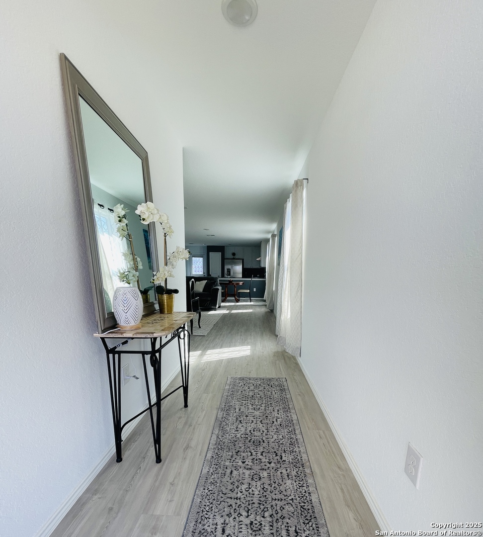 6948 Calcite Trail Elmendorf, TX 78112 - Photo 3 of 12 a view of a hallway to a livingroom and furniture