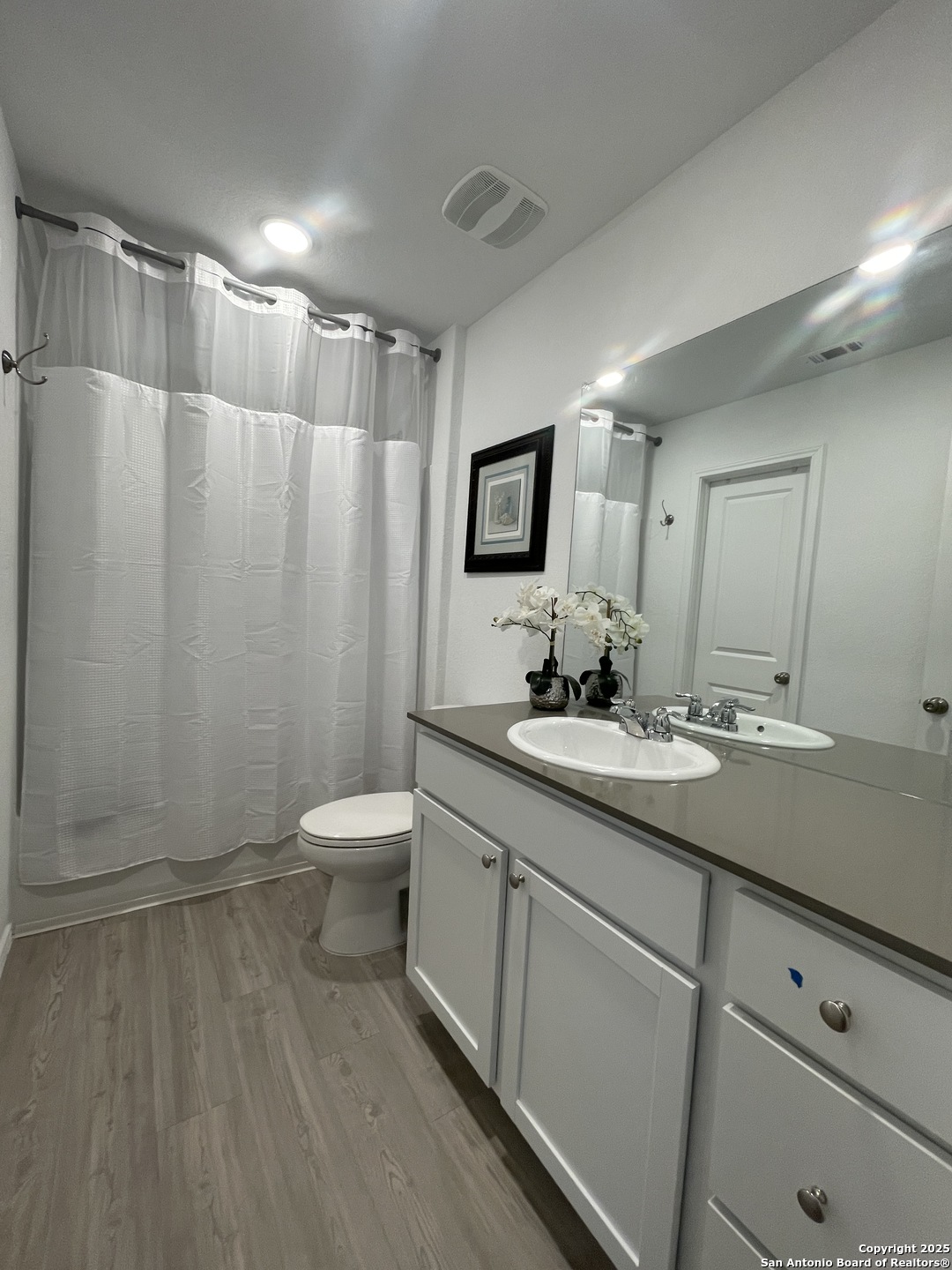 6948 Calcite Trail Elmendorf, TX 78112 - Photo 10 of 12 a bathroom with a double vanity sink toilet and mirror