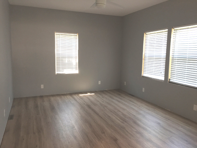 119 East Minnesota Street Spring Valley, IL 61362 - Photo 4 of 15 an empty room with wooden floor and windows