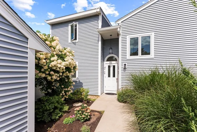 a view of a big building with a big yard and large trees