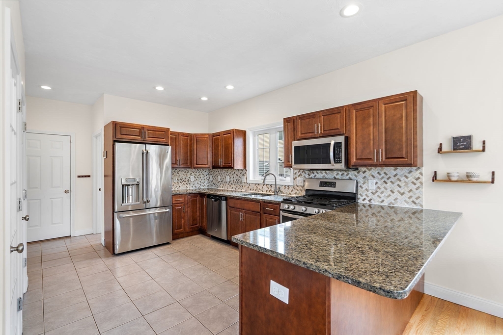 2 Northern Lights Way Bellingham, MA 02019 - Photo 12 of 40 a kitchen with stainless steel appliances granite countertop a refrigerator stove and oven