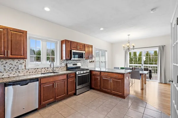 a kitchen with lots of counter top space sink and stainless steel appliances