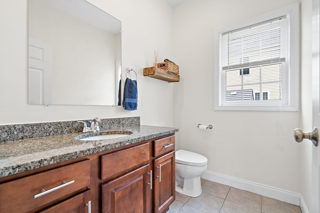 2 Northern Lights Way Bellingham, MA 02019 - Photo 15 of 40 a bathroom with a granite countertop sink a toilet and a mirror