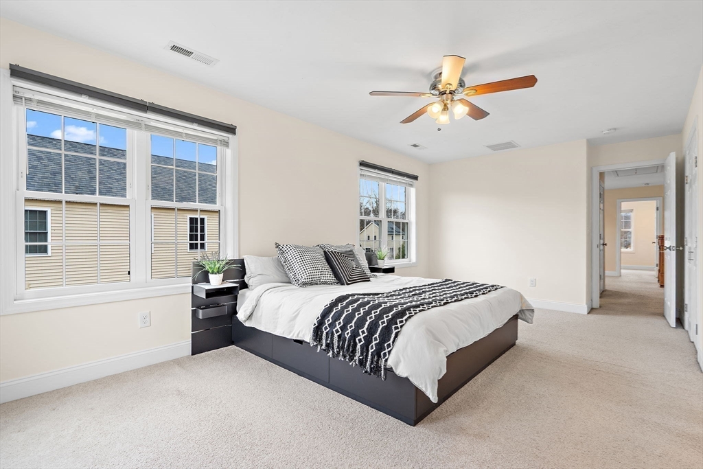 2 Northern Lights Way Bellingham, MA 02019 - Photo 20 of 40 a spacious bedroom with a large bed and a chandelier