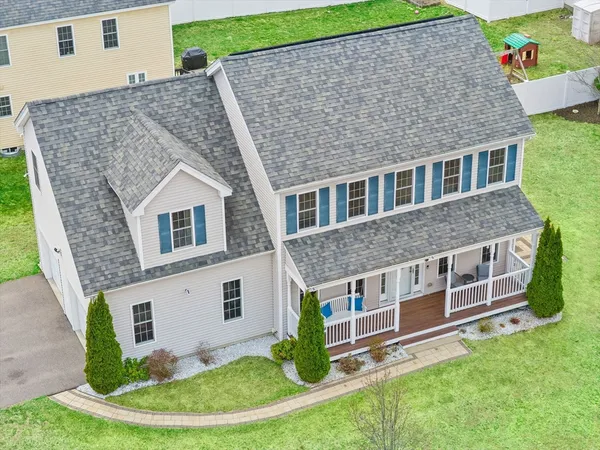 a aerial view of a house with a yard potted plants