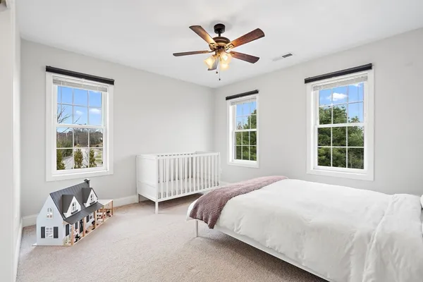 a bedroom with a bed and a chandelier