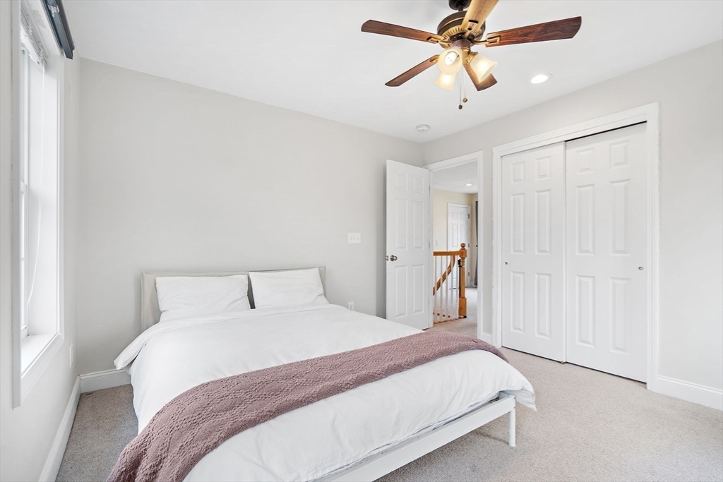 2 Northern Lights Way Bellingham, MA 02019 - Photo 25 of 40 a bedroom with a bed and a chandelier