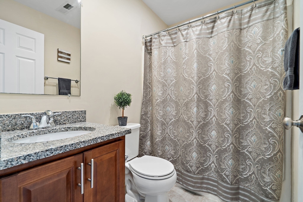 2 Northern Lights Way Bellingham, MA 02019 - Photo 28 of 40 a bathroom with a granite countertop sink and a toilet