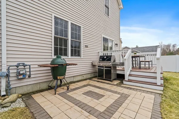 a view of a chairs and tables in the back yard of the house
