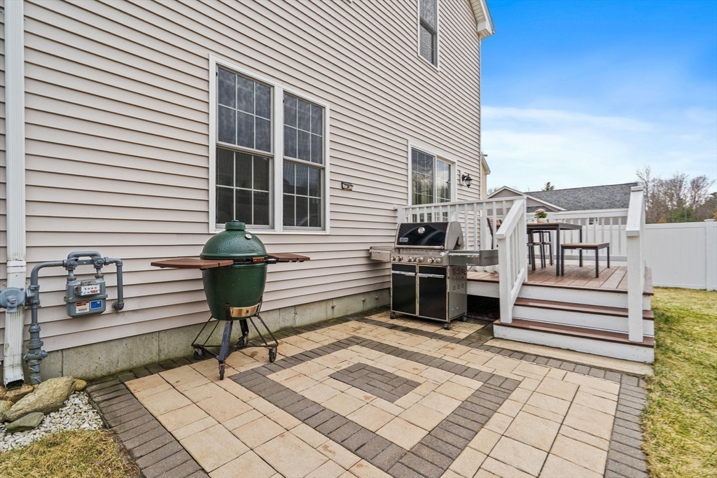 2 Northern Lights Way Bellingham, MA 02019 - Photo 10 of 40 a view of a chairs and tables in the back yard of the house