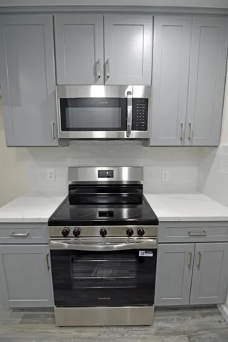 a stove top oven sitting inside of a kitchen