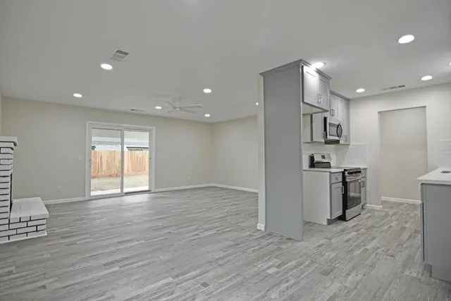 a view of a kitchen with a sink and a stove top oven