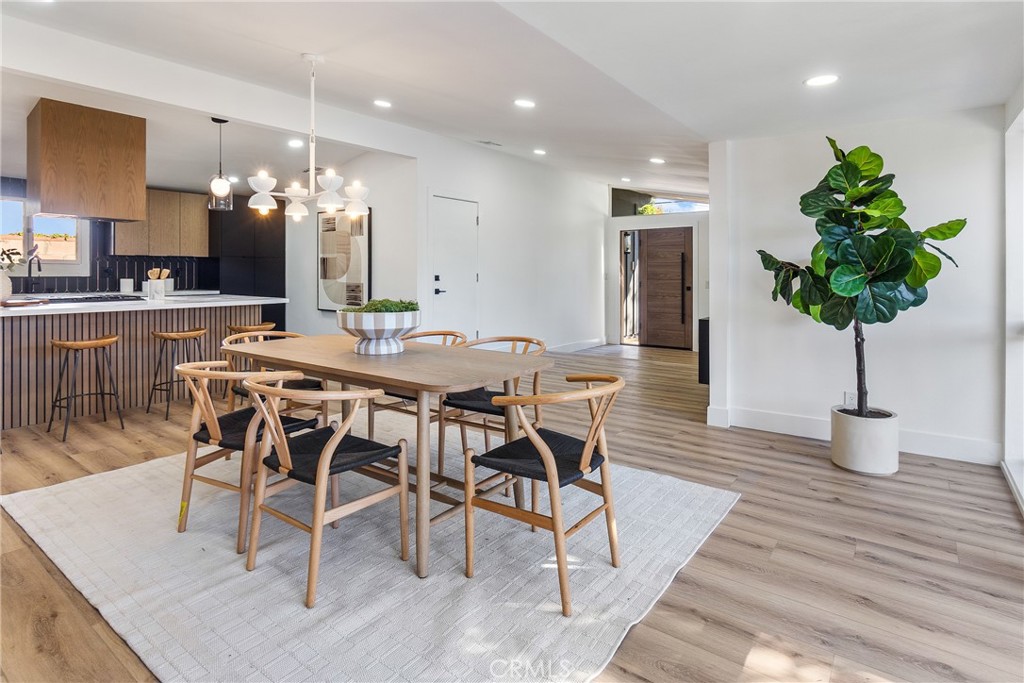 6909 De Celis Place Van Nuys, CA 91406 - Photo 1 of 46 a dining room filled chandelier and wooden floor