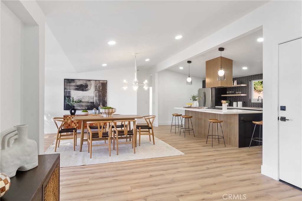 6909 De Celis Place Van Nuys, CA 91406 - Photo 11 of 46 a view of a dining area with furniture and wooden floor