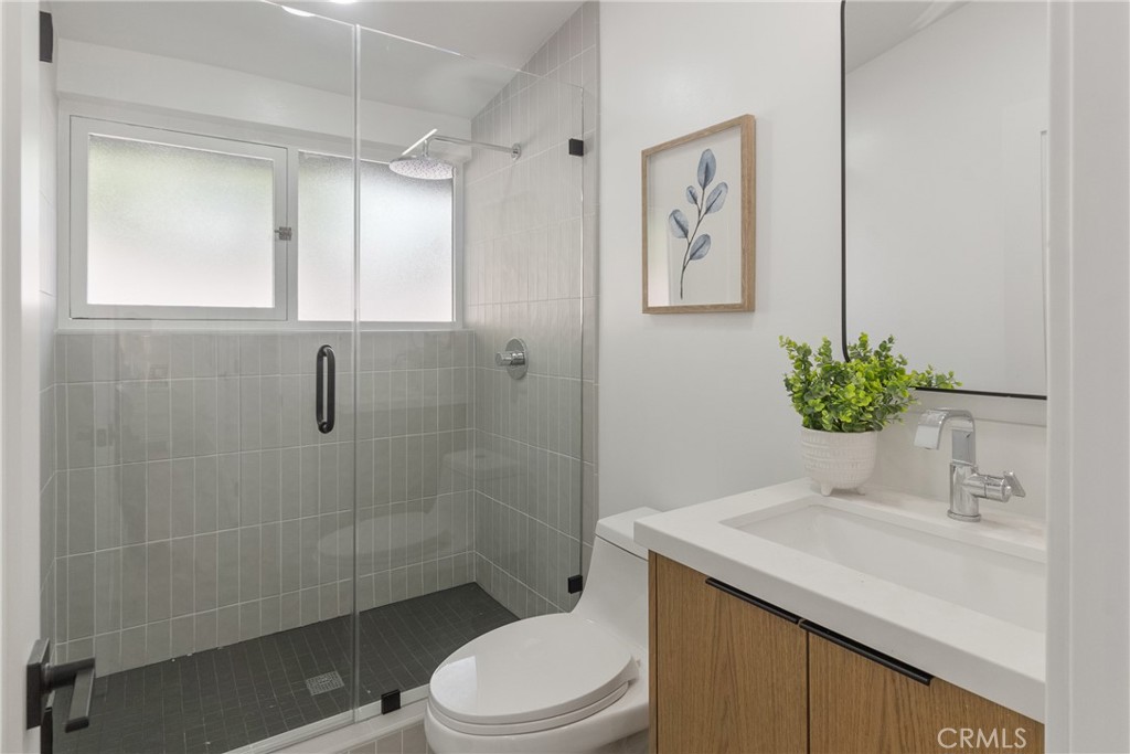 6909 De Celis Place Van Nuys, CA 91406 - Photo 12 of 46 a bathroom with a sink a toilet and shower