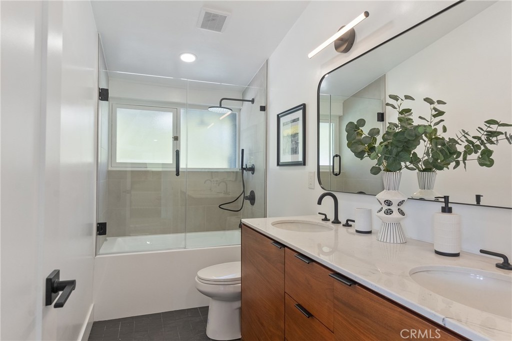 6909 De Celis Place Van Nuys, CA 91406 - Photo 14 of 46 a bathroom with a double vanity sink toilet and shower
