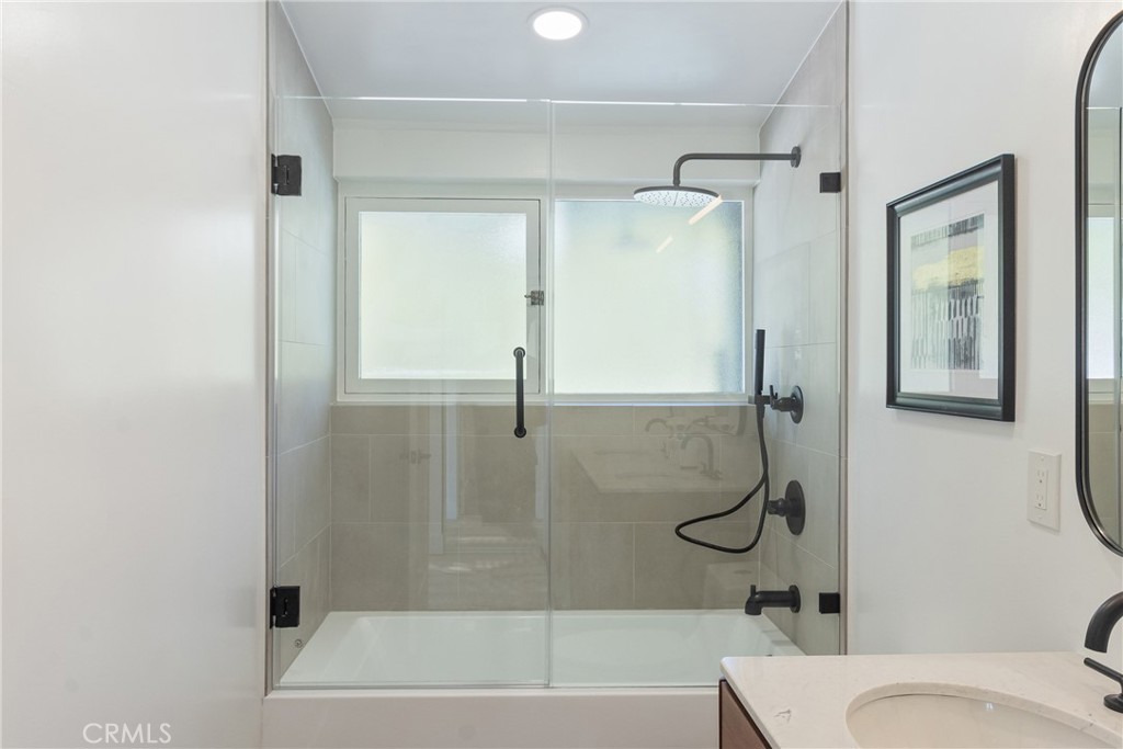 6909 De Celis Place Van Nuys, CA 91406 - Photo 15 of 46 a bathroom with a granite countertop bathtub shower and toilet