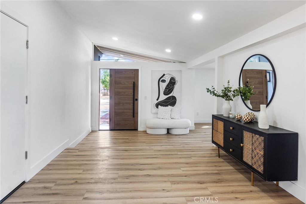 6909 De Celis Place Van Nuys, CA 91406 - Photo 19 of 46 a living room with furniture and a wooden floor