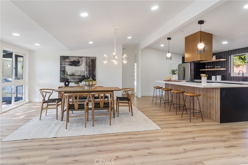 6909 De Celis Place Van Nuys, CA 91406 - Photo 2 of 46 a view of a dining room with furniture and wooden floor