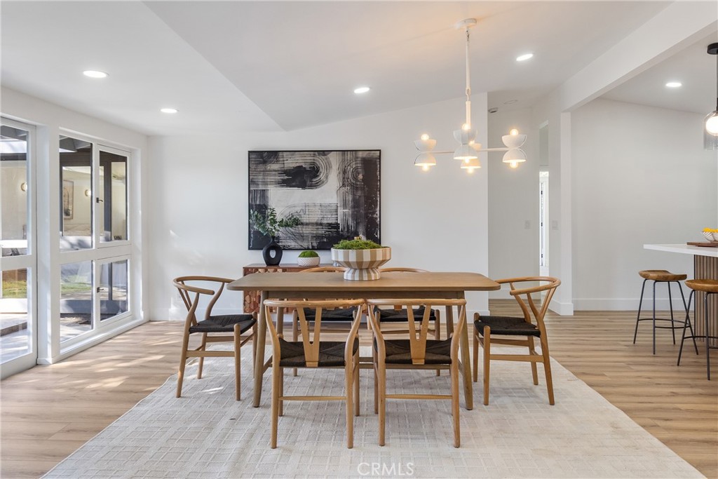 6909 De Celis Place Van Nuys, CA 91406 - Photo 21 of 46 a dining room with furniture and wooden floor