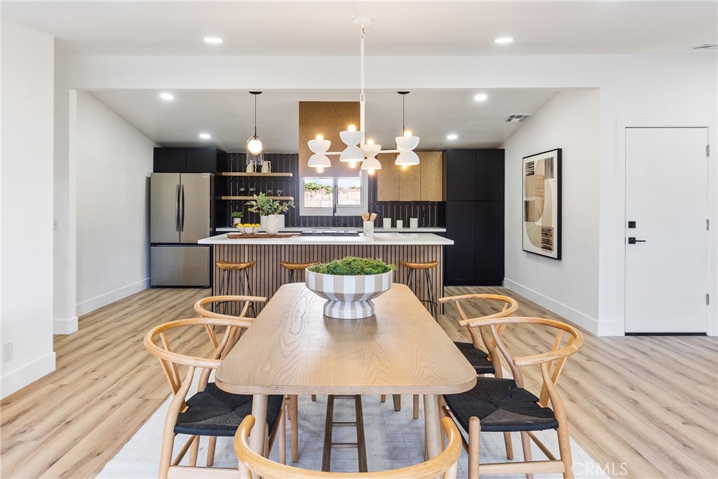 6909 De Celis Place Van Nuys, CA 91406 - Photo 22 of 46 a view of a dining room with furniture and wooden floor