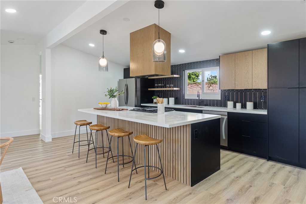 6909 De Celis Place Van Nuys, CA 91406 - Photo 23 of 46 a kitchen with a dining table chairs and cabinets