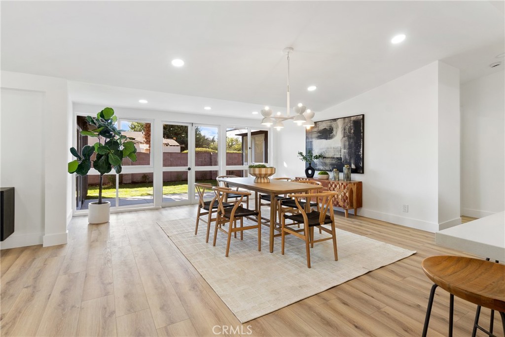 6909 De Celis Place Van Nuys, CA 91406 - Photo 26 of 46 a view of a dining room with furniture and wooden floor