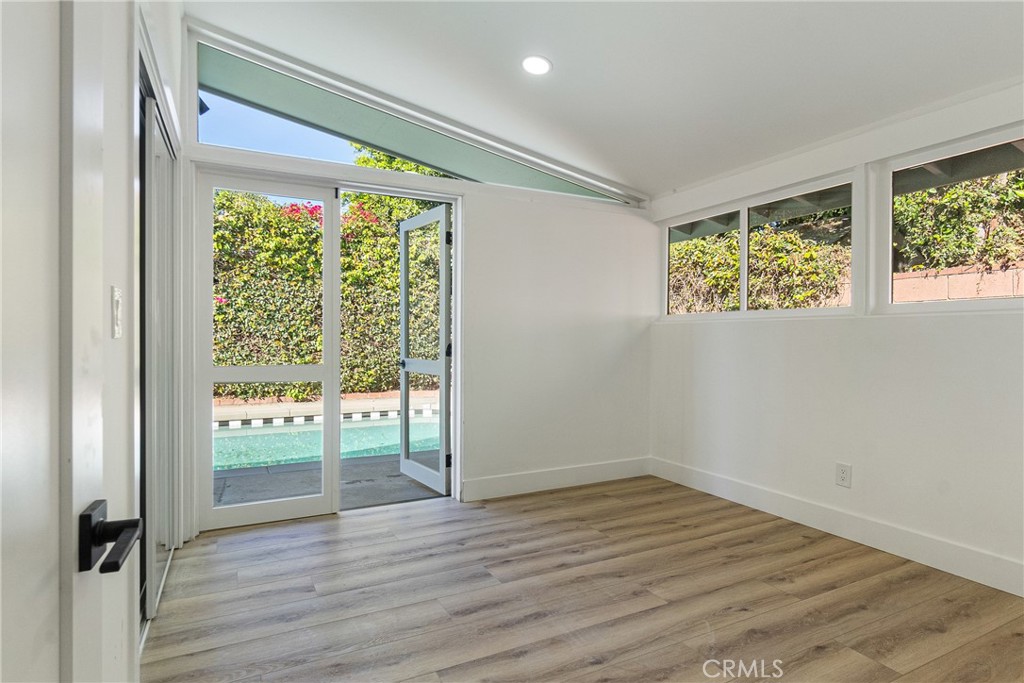 6909 De Celis Place Van Nuys, CA 91406 - Photo 29 of 46 an empty room with wooden floor and windows