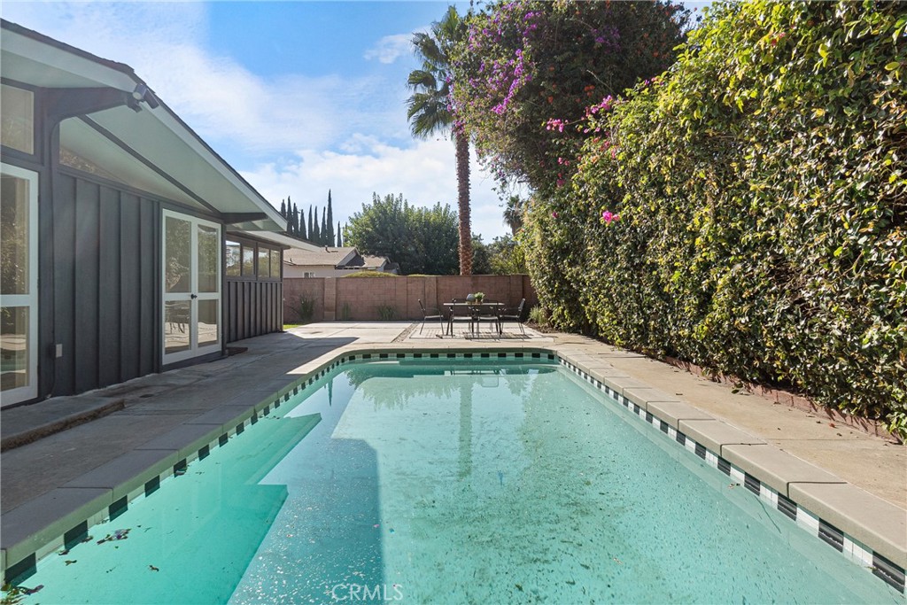 6909 De Celis Place Van Nuys, CA 91406 - Photo 30 of 46 a view of a swimming pool with a yard