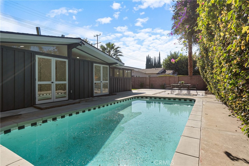6909 De Celis Place Van Nuys, CA 91406 - Photo 31 of 46 a view of a swimming pool with a yard