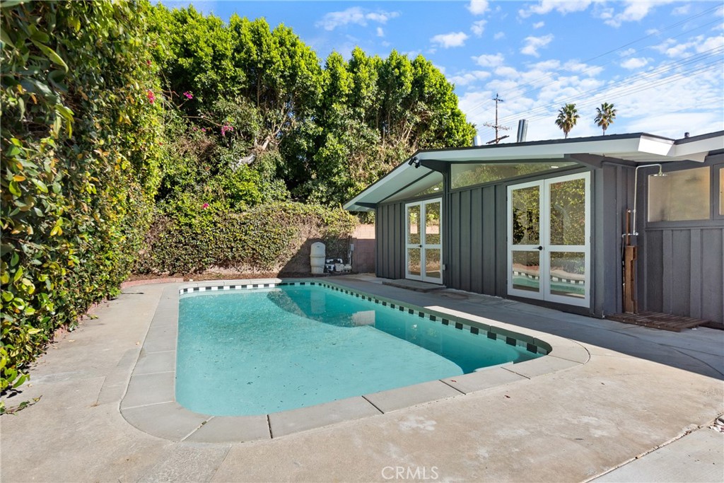 6909 De Celis Place Van Nuys, CA 91406 - Photo 32 of 46 a front view of a house with a yard and garage