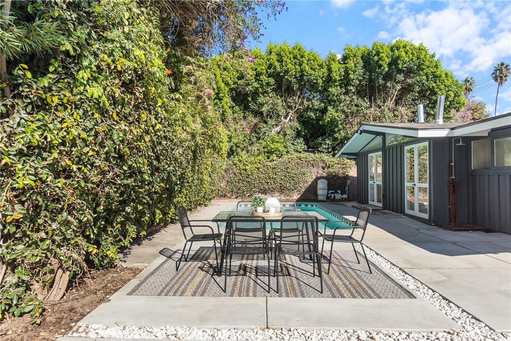 6909 De Celis Place Van Nuys, CA 91406 - Photo 35 of 46 a view of a patio with table and chairs and wooden floor