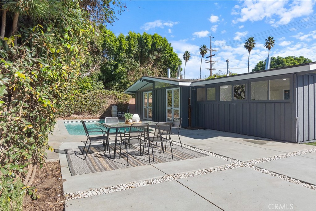 6909 De Celis Place Van Nuys, CA 91406 - Photo 36 of 46 a view of a patio with table and chairs and potted plants