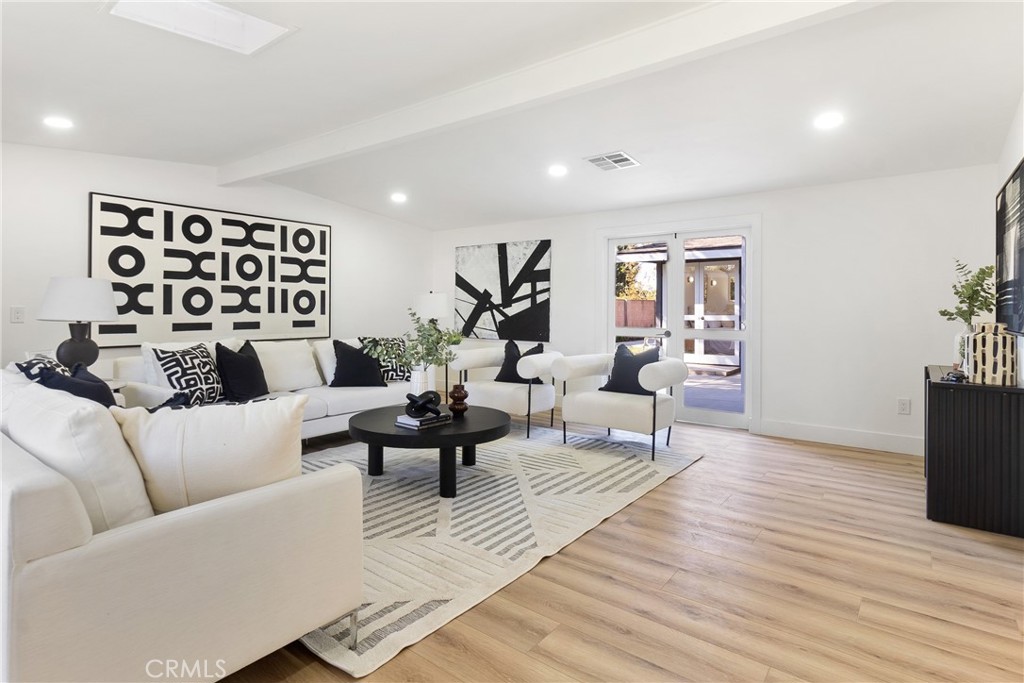 6909 De Celis Place Van Nuys, CA 91406 - Photo 7 of 46 a living room with furniture and wooden floor