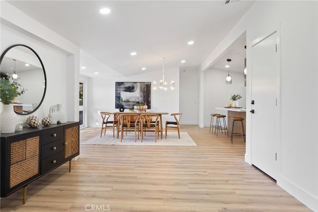 6909 De Celis Place Van Nuys, CA 91406 - Photo 10 of 46 a living room with furniture a table and kitchen view