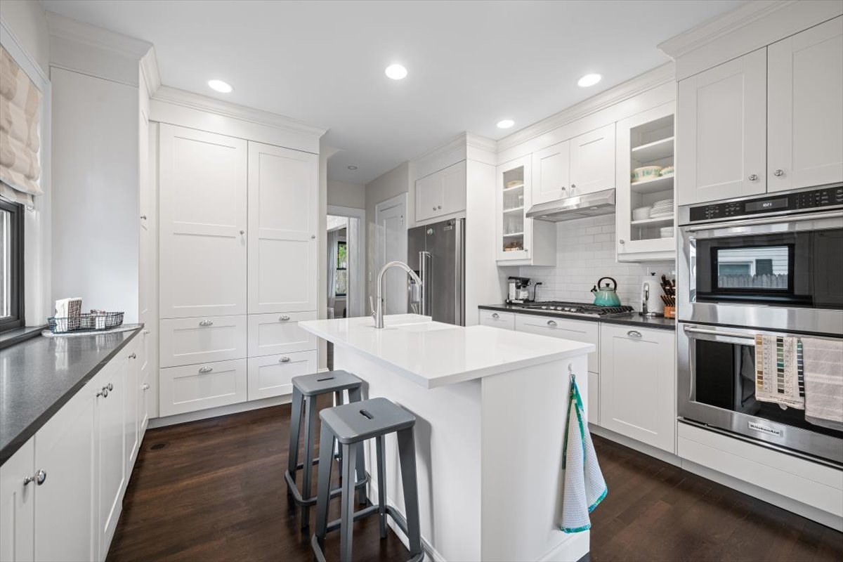 198 Wildwood Road Lake Forest, IL 60045 - Photo 17 of 37 a kitchen with white cabinets and stainless steel appliances