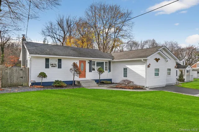 a front view of house with yard and green space