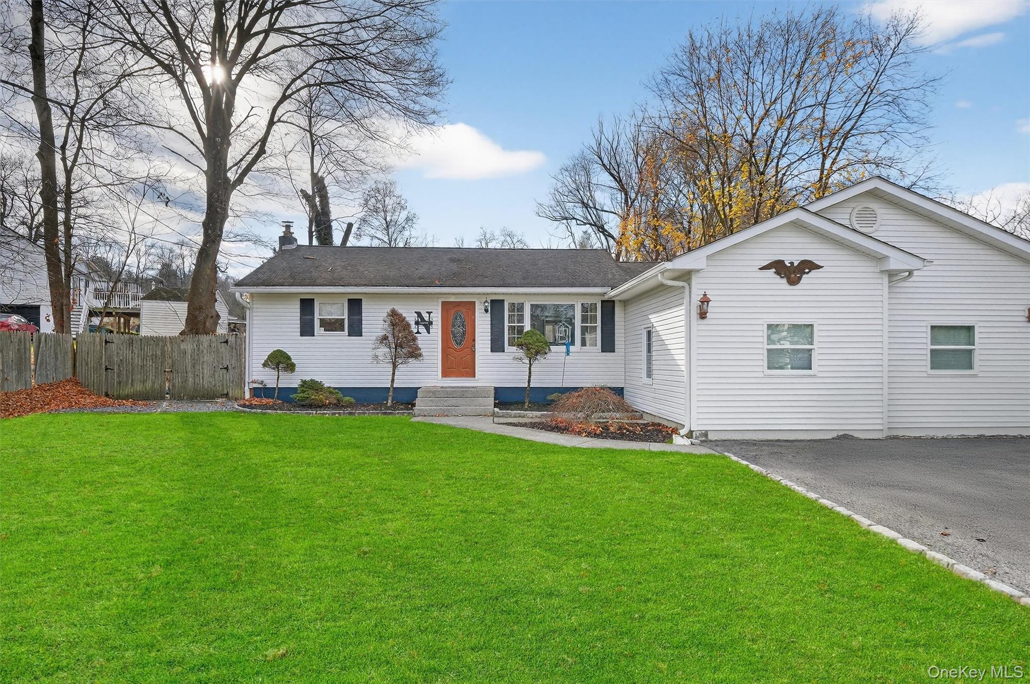 a view of a house with a yard and sitting area