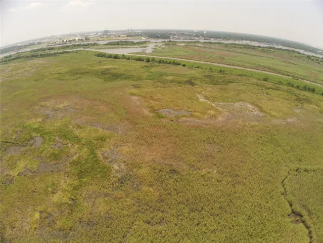 a view of a field with an ocean view