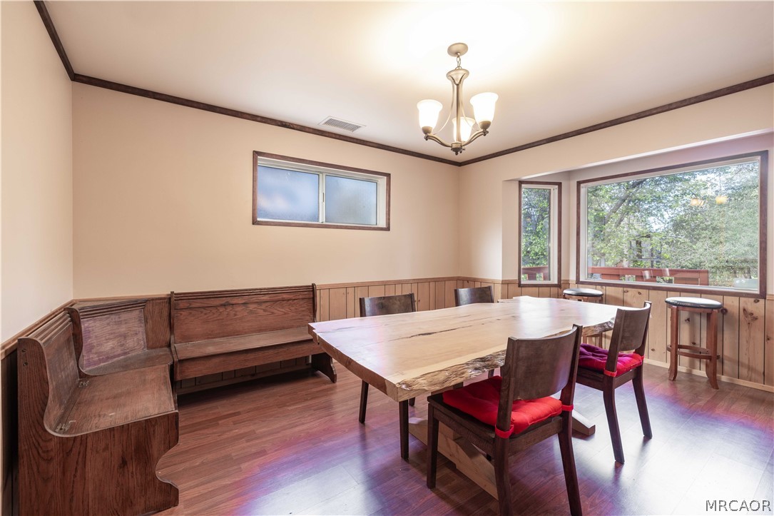 773 Sunset Lane Sugarloaf, CA 92386 - Photo 9 of 33 a view of a dining room with furniture window and wooden floor
