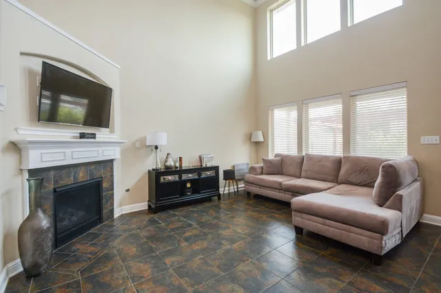 a living room with furniture a flat screen tv and a fireplace