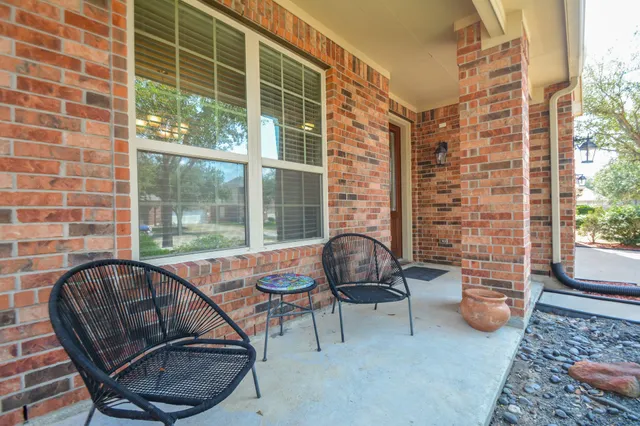 a front view of a house with a tree