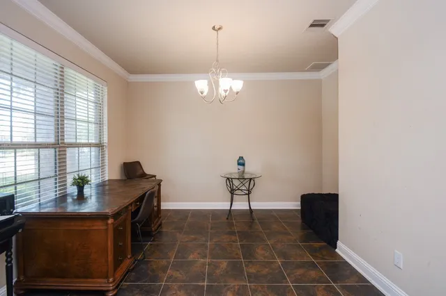 a dining room with furniture and window
