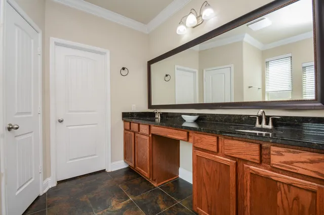a view of a kitchen with stainless steel appliances granite countertop a stove and a microwave oven