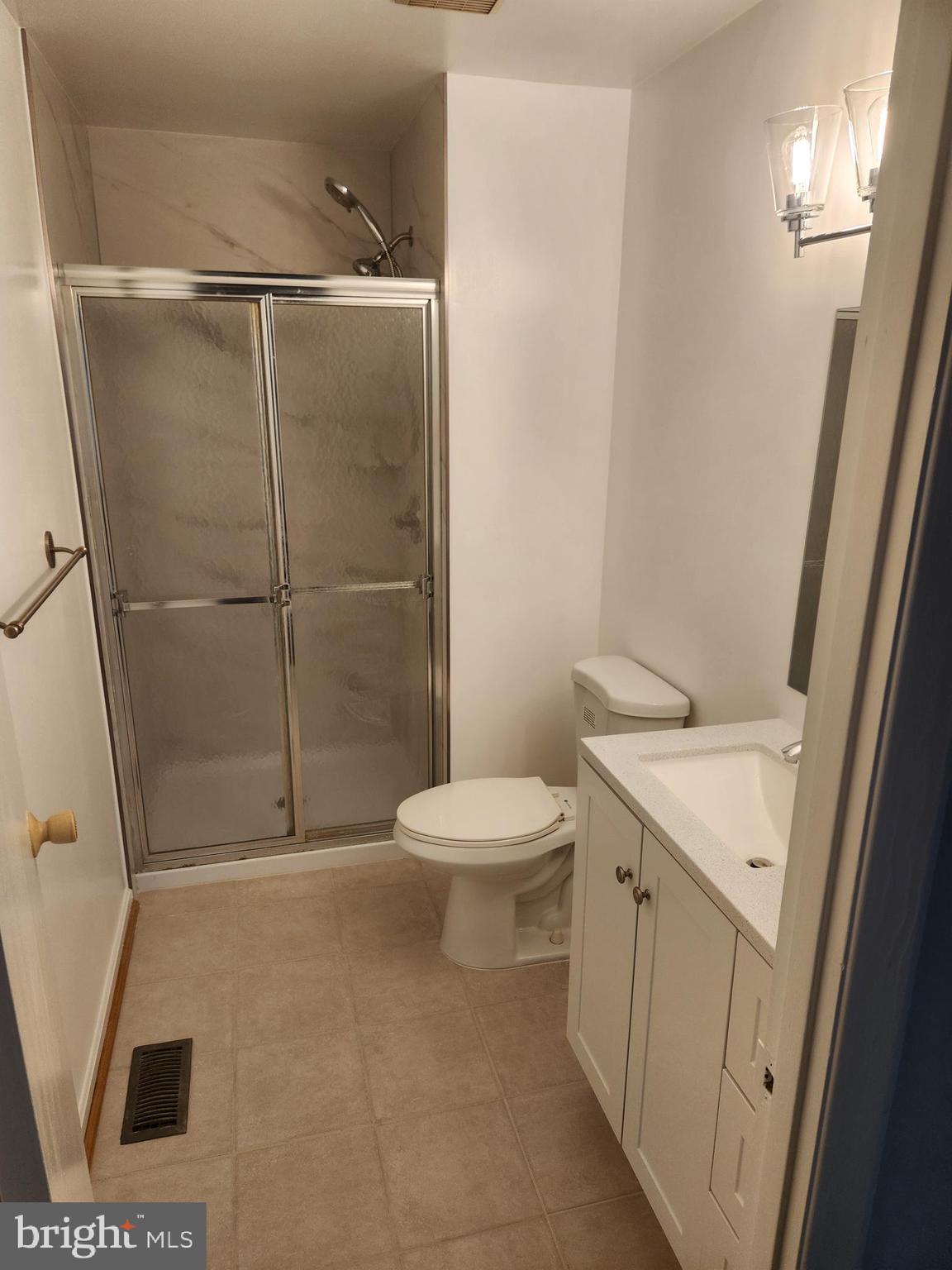 7104 Lasting Light Way Columbia, MD 21045 - Photo 12 of 40 a bathroom with a granite countertop sink toilet and shower