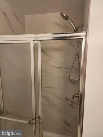 a bathroom with a glass door shower