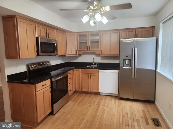a kitchen with a refrigerator stove top oven and cabinets
